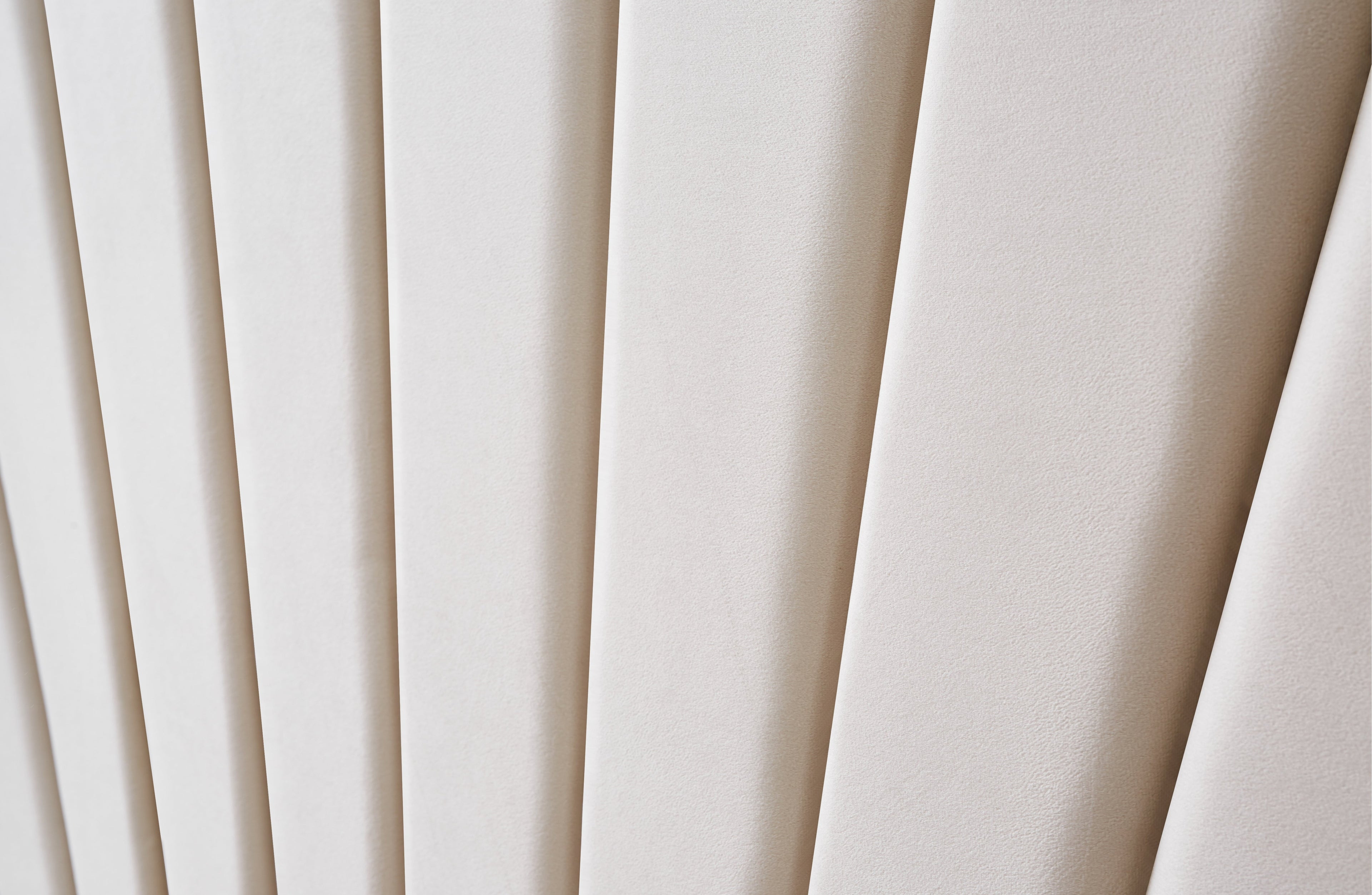 Detailed view of Allure Velvet Bed Beige headboard with vertical tufting and soft velvet texture.