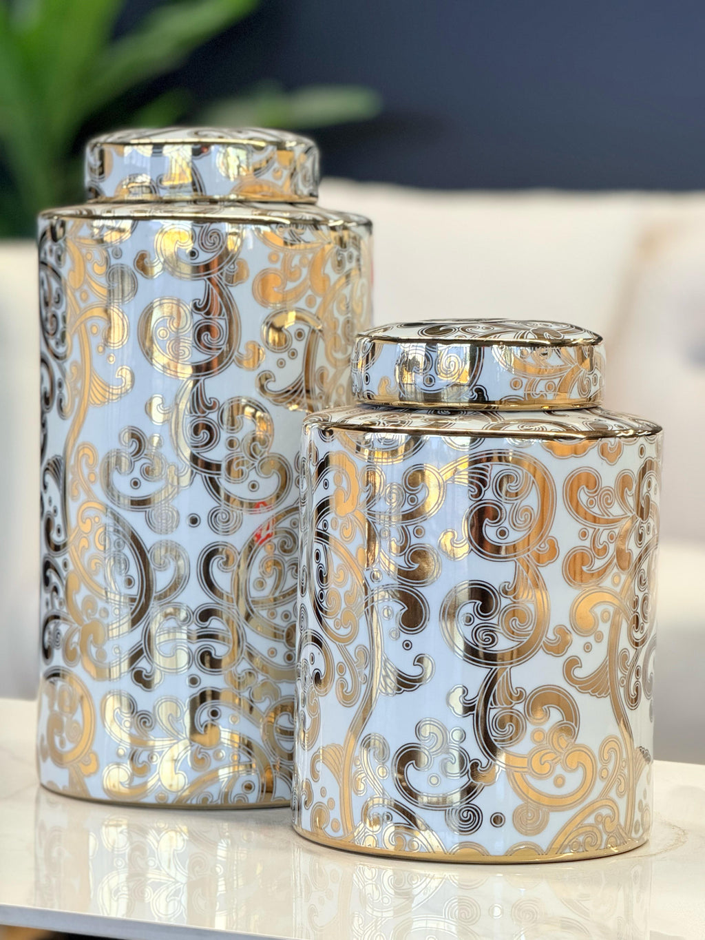 Armani Ceramic Canisters styled on a white surface with background décor – features white base with ornate gold and black detailing