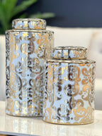 Armani Ceramic Canisters styled on a white surface with background décor – features white base with ornate gold and black detailing