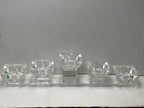 Crystal-clear tea light candle holder with five diamond-shaped cups on a long rectangular base