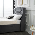 Dark grey velvet bed side view.