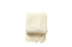 Cream Tessa throw rug blanket with a soft textured weave and fringe edges.