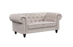 Beige Chesterfield tufted two-seater sofa with rolled arms and timber legs