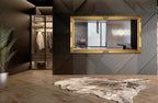 Gold French provincial deluxe mirror styled horizontally in modern dark interior with rug and décor.