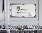 Silver French provincial deluxe mirror styled horizontally above sofa with tufted seating and shelves.