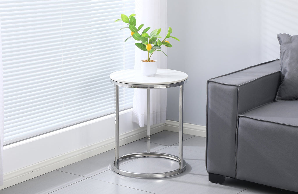 Layla side table with silver frame and marble top styled beside a contemporary sofa.