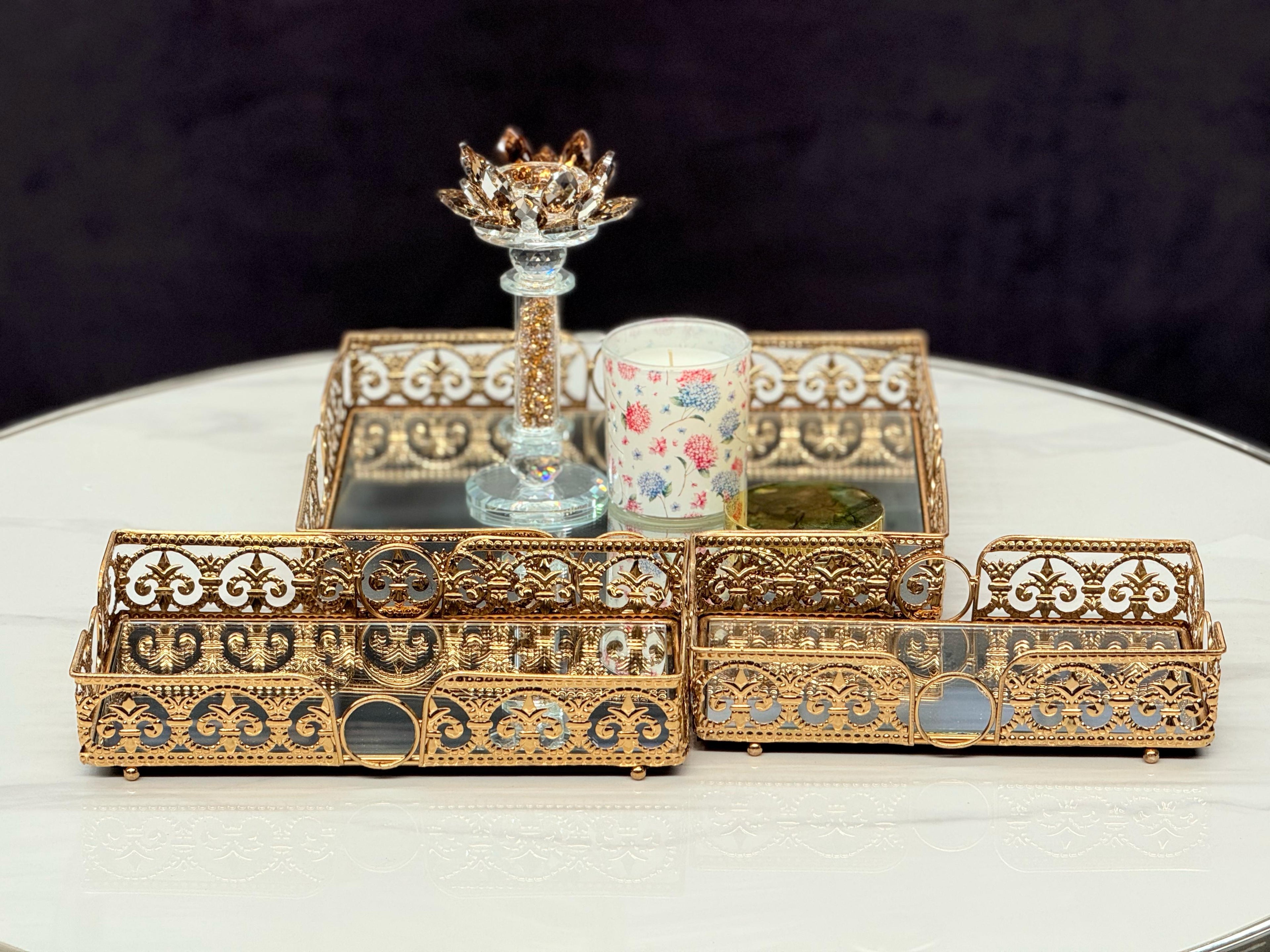 Set of gold rectangle Lucy trays styled with candles and decor – a perfect touch of opulence for your tabletop.