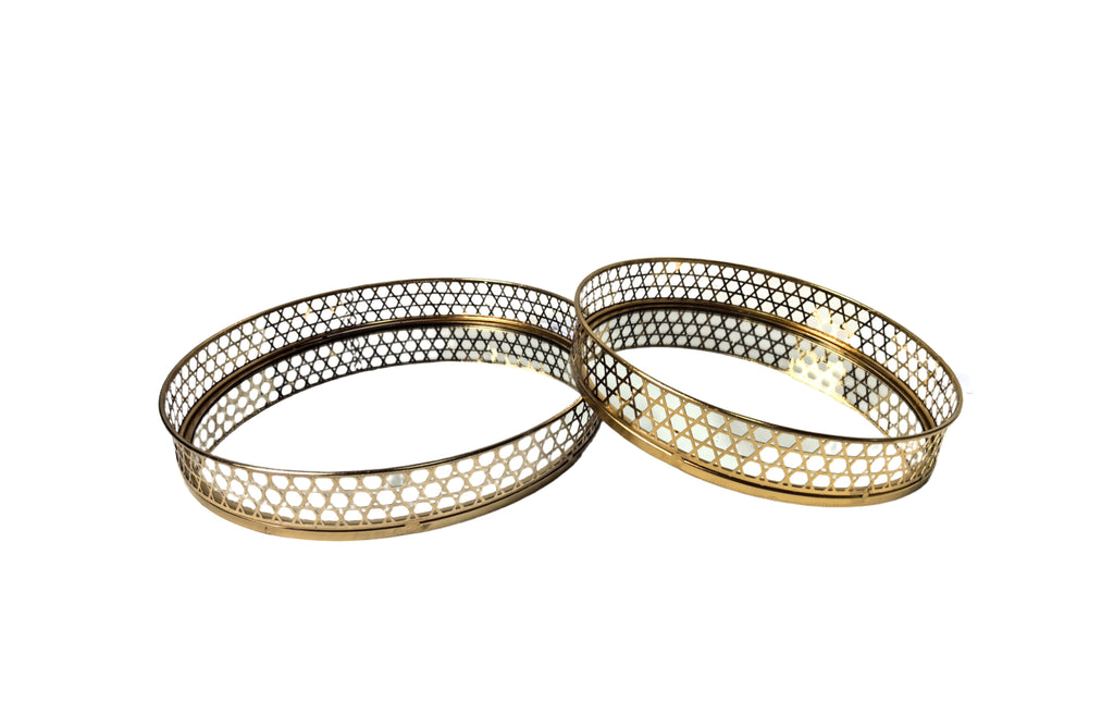 Luxurious gold round tray set with mirrored base and elegant lattice border.
