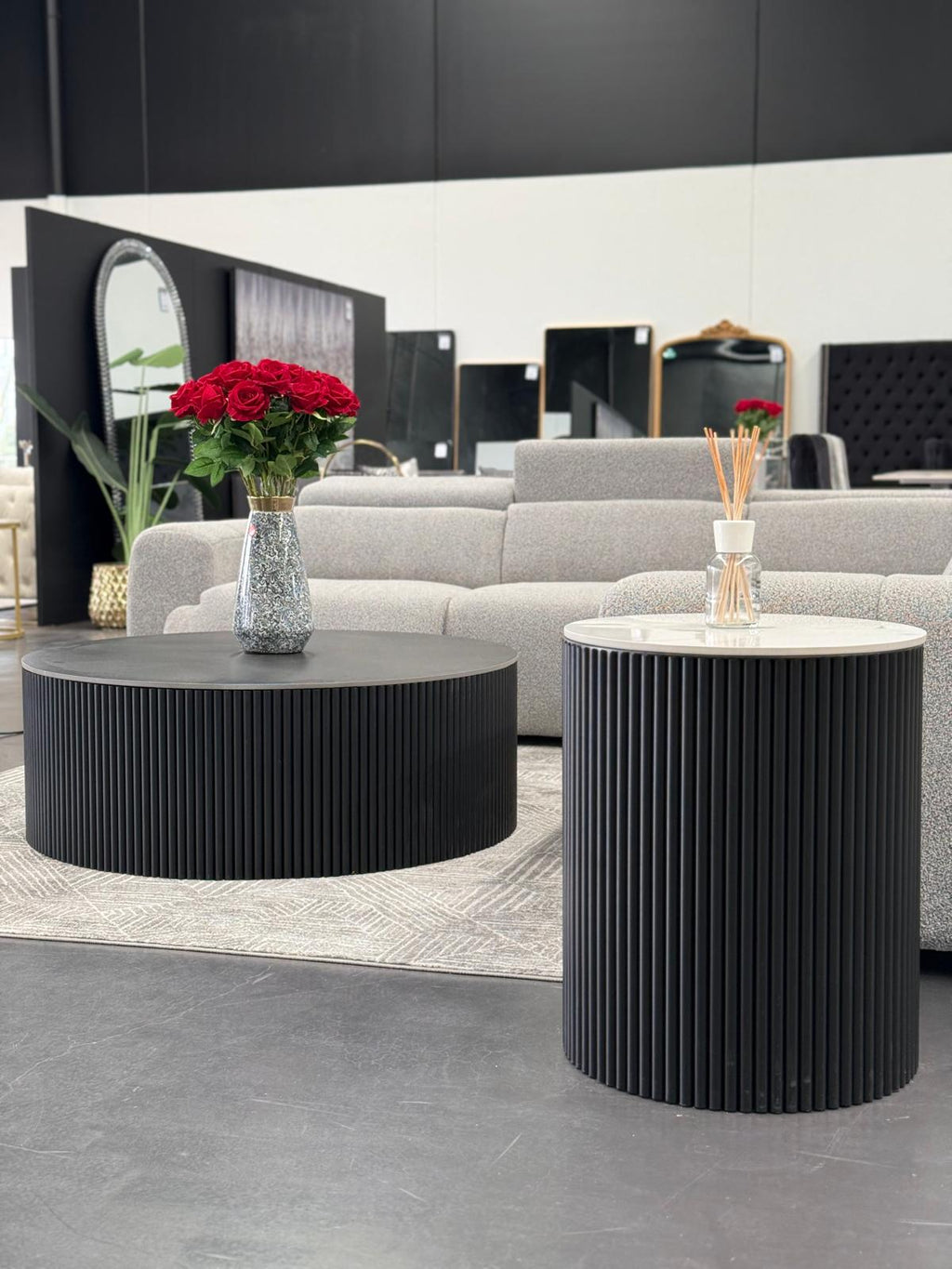 Ripple coffee and side table styled in living room with grey sofa and flowers